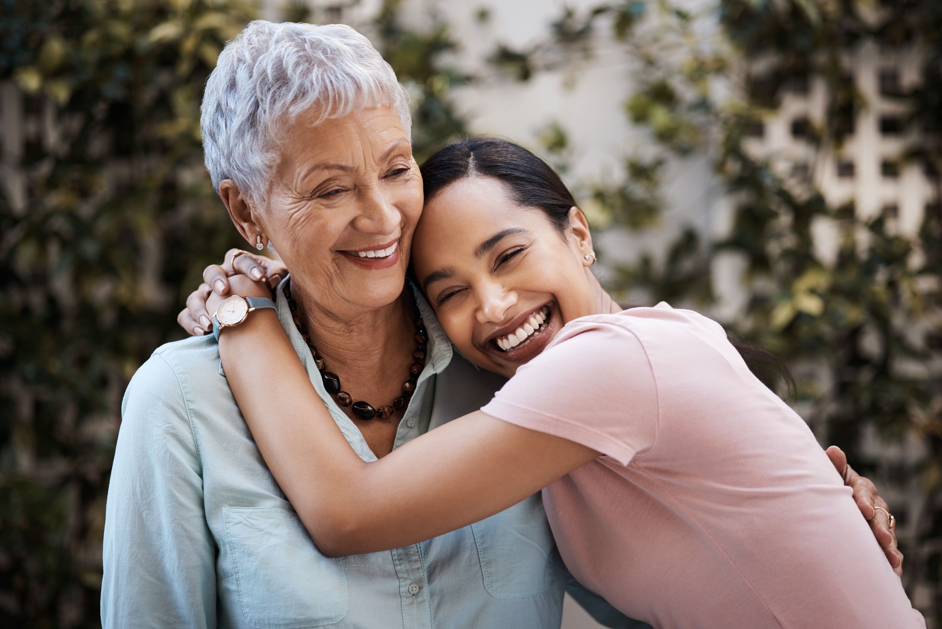 Shot of a senior woman spending time with her daughter in their garden at home