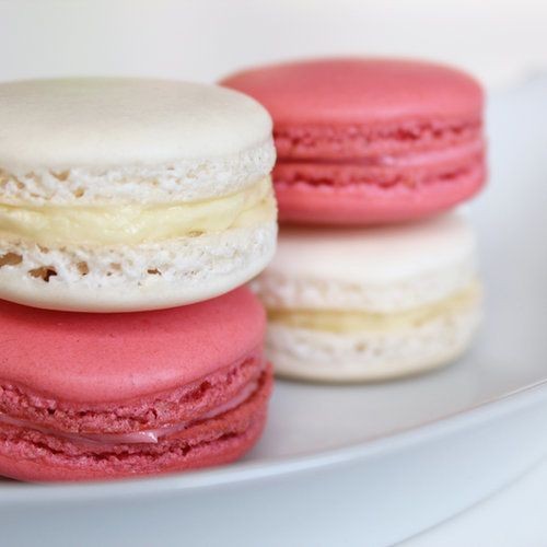4 pink and white macarons